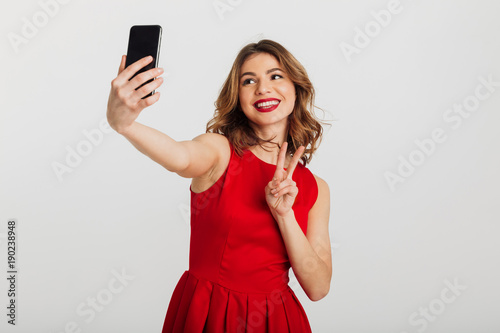 Portrait of a happy young woman dressed in red dress