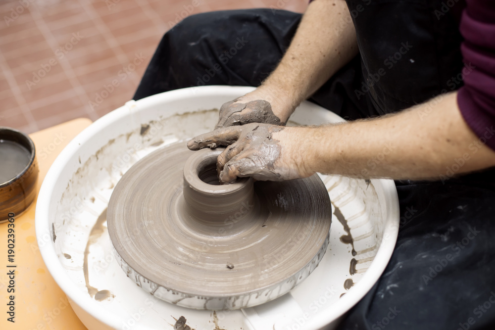 Artist makes clay pottery on a spin wheel Artist makes clay pottery on a spin wheel