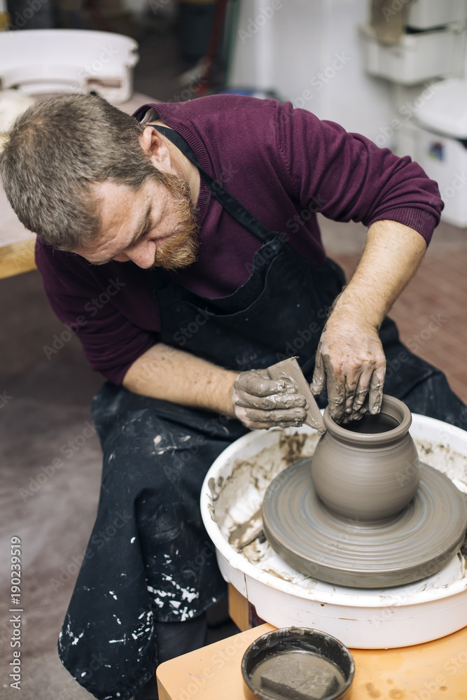 Artist makes clay pottery on a spin wheel Artist makes clay pottery on a spin wheel