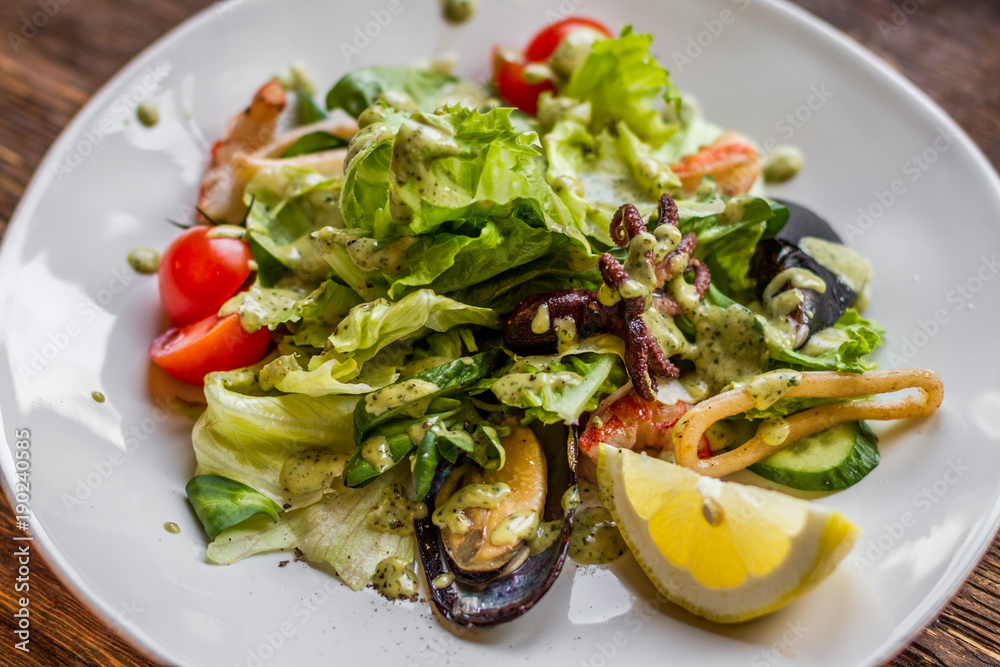 Tasty salad with seafood on a white plate Tasty salad with seafood on a white plate
