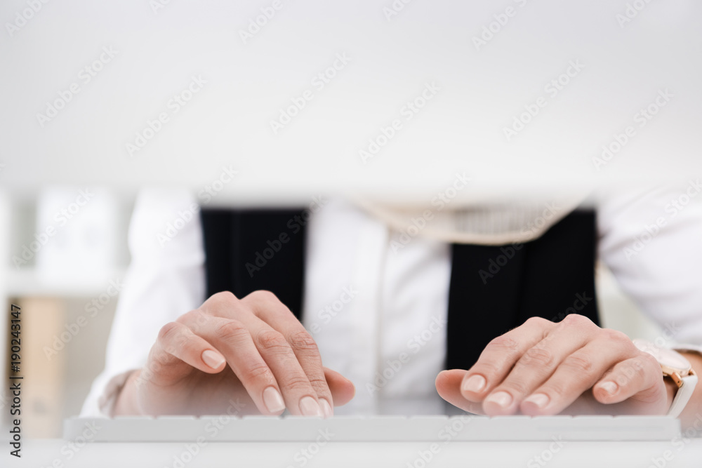 partial view of businesswoman working on computer in office partial view of businesswoman working on computer in office