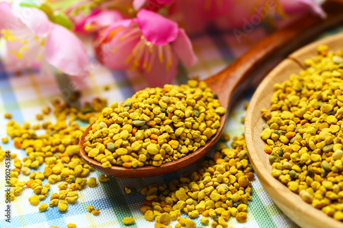 Bee pollen in wooden plate and spoon