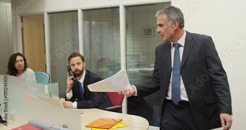 4K Aggressive business manager yelling at female employee & throwing papers. Realistic business concept of workplace issues