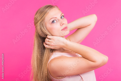 Happy Blonde Woman on pink background. Smiling Fashion Model with Hairstyle