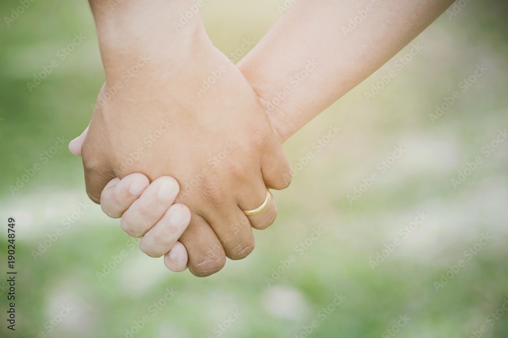 Woman and man holding hands, Happy couple love in the garden. concept couple lover valentine day. Woman and man holding hands, Happy couple love in the garden. concept couple lover valentine day.