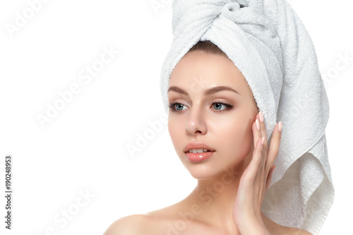 Portrait of young beautiful woman touching her face