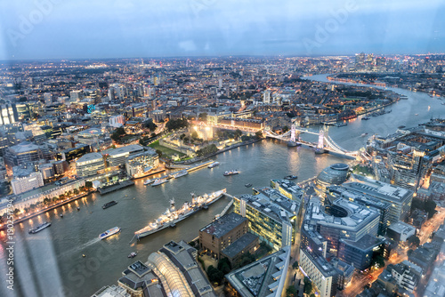 Tower Bridge and city skyline along river Thames at night  aerial view - London - UK