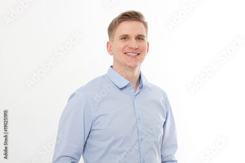 Young smiling businessman isolated on white background. Copy space and mock up. Man in blue template and blank shirt.