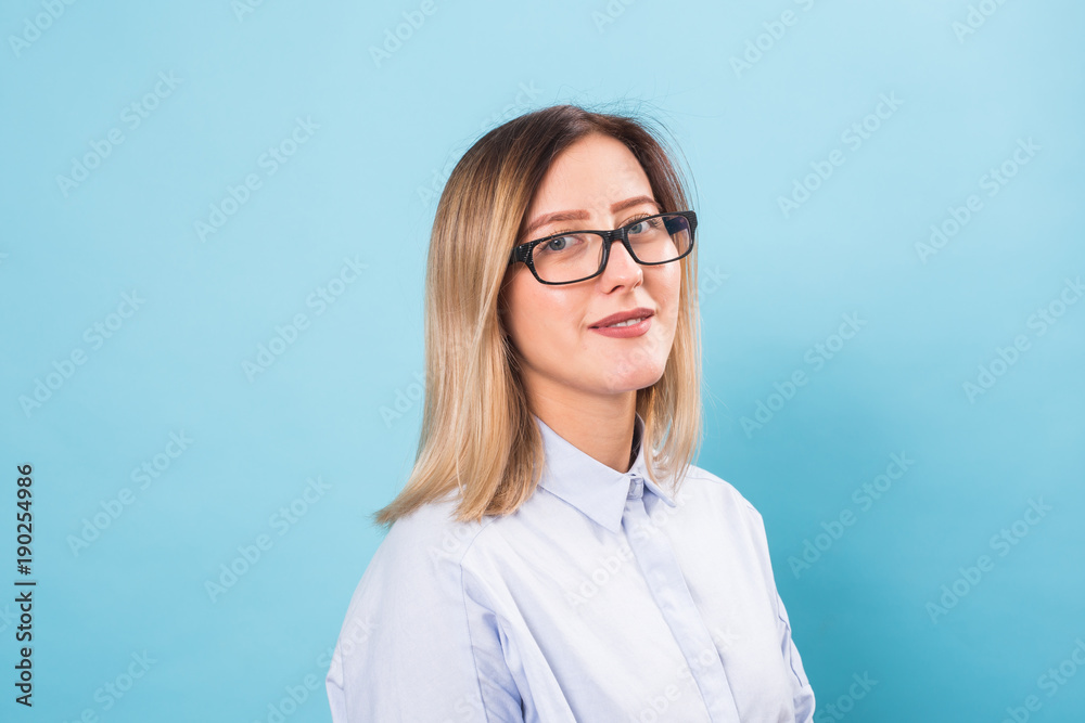 Young lady in glasses on blue background Young lady in glasses on blue background
