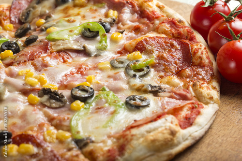 Italian Capriciosa pizza made with salami and vegetables