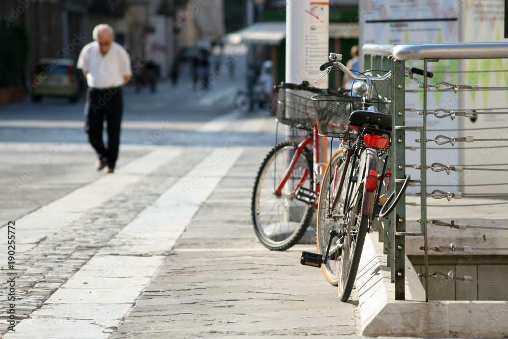 Summer. Italy. Bicycle on the square with paving stones Summer. Italy. Bicycle on the square with paving stones