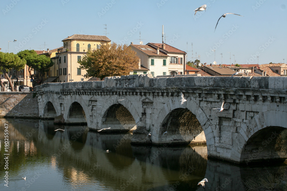 Summer. Italy. Rimini. Bridge of Tiberius. Gulls on the bridge. Colorful