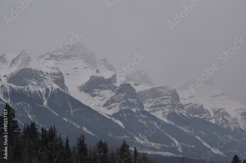 Snow Covered Rocky Mountains with Hazy Grey Sky © royalkangas