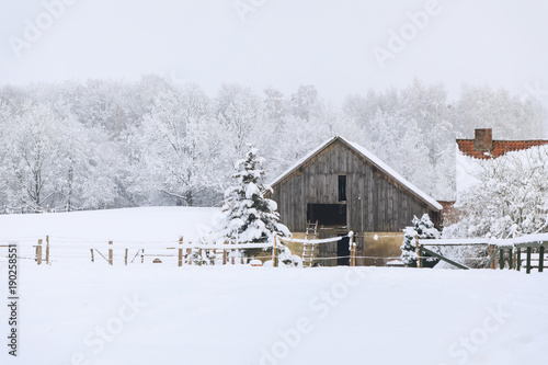 Wooden abandoned house in a deep winter