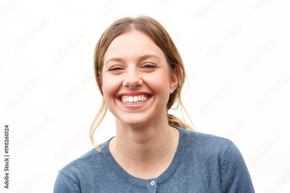 Close up happy young woman smiling against white background Close up happy young woman smiling against white background