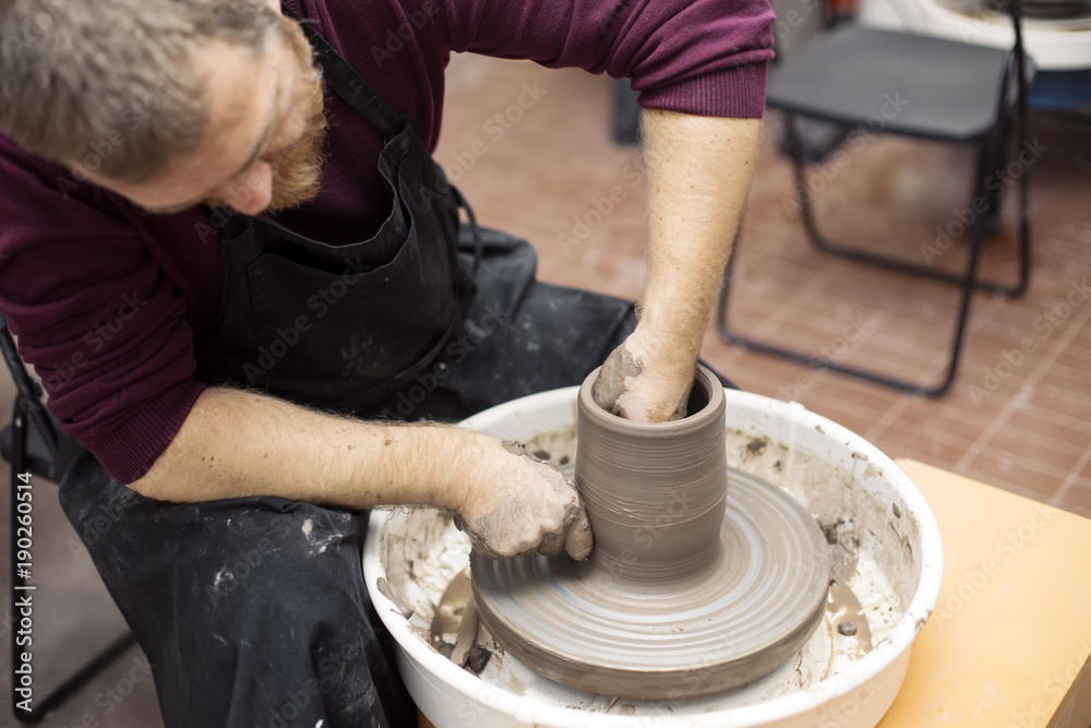 Artist makes clay pottery on a spin wheel Artist makes clay pottery on a spin wheel