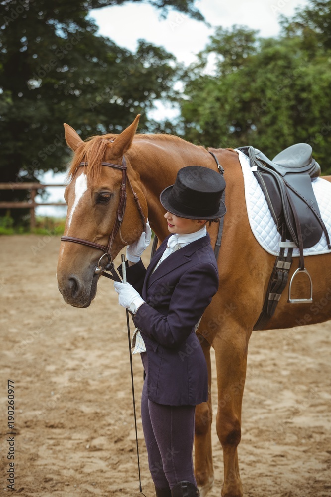 Female jockey leading her horse Female jockey leading her horse