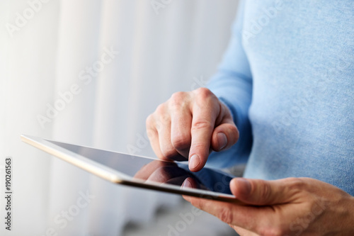 Male hand presses on screen digital tablet