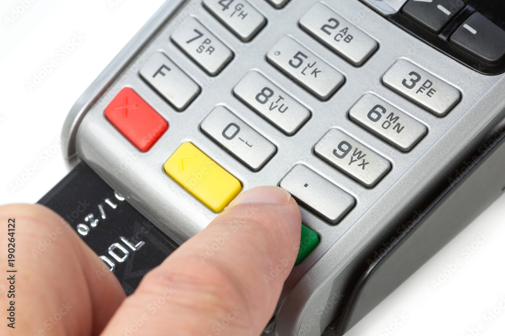 a person typing his credit card code on a payment terminal a person typing his credit card code on a payment terminal
