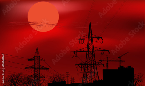 buildings and electric pylon at red sunset