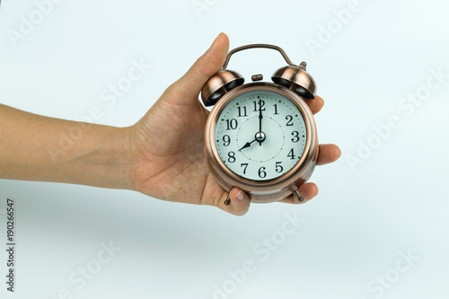 hands holding Vintage alarm clock