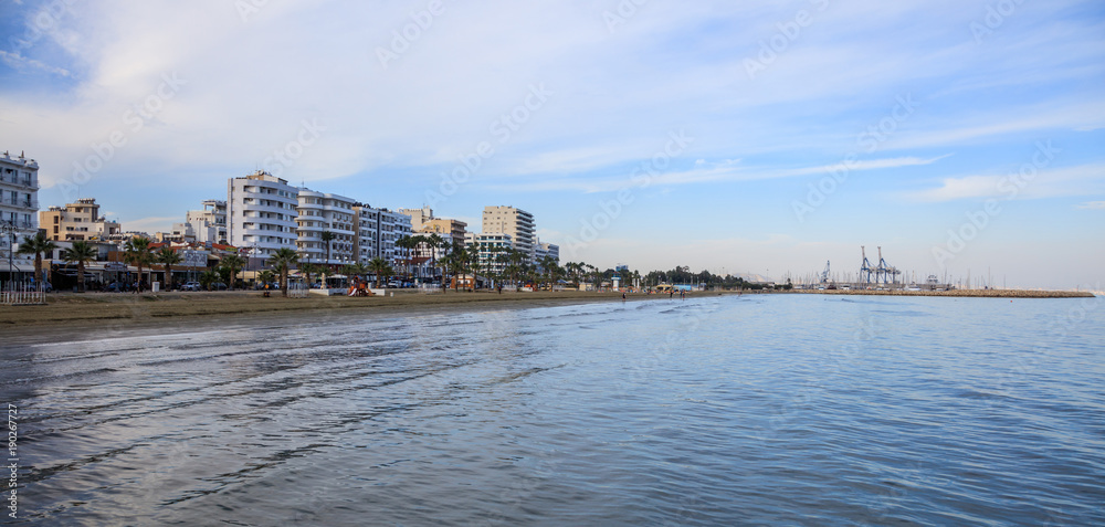 Finikoudes beach, Cyprus. Blue sky and clouds over city of Larnaca for background. Space, banner