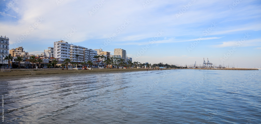 Finikoudes beach, Cyprus. Blue sky and clouds over city of Larnaca for background. Space, banner Finikoudes beach, Cyprus. Blue sky and clouds over city of Larnaca for background. Space, banner