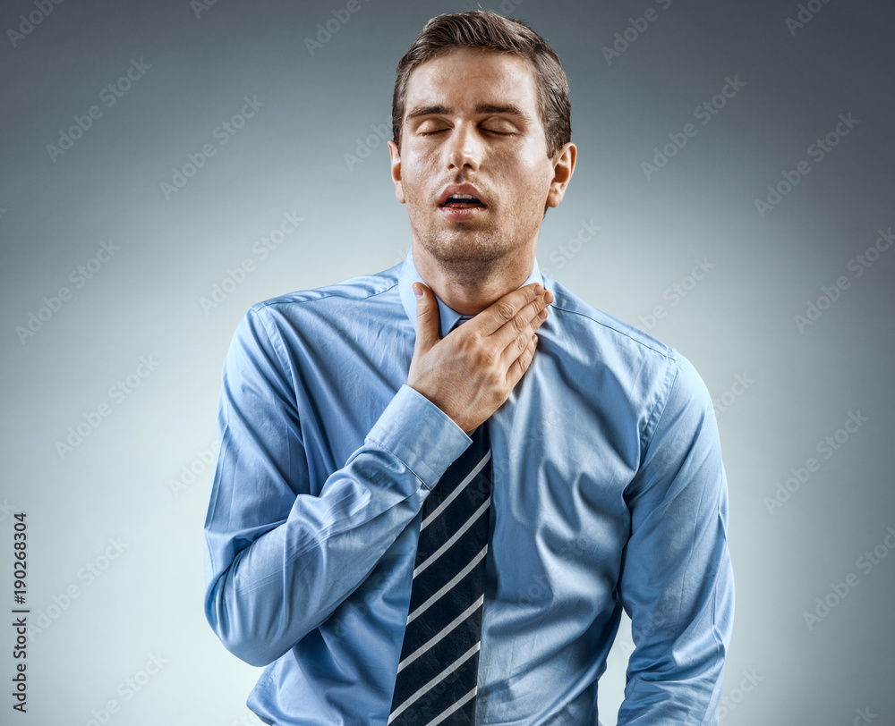 Throat Pain. Office worker holding his inflamed throat. Photo of man in