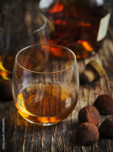 Glass of cognac and chocolate truffles