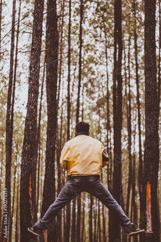 A man jumping in the forest