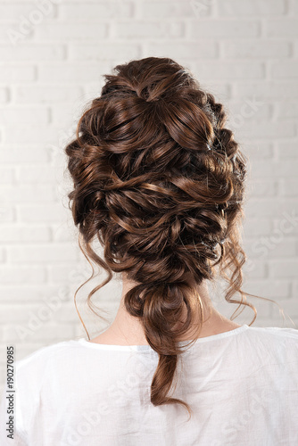 Head with elegant wedding hairstyle on gray background rear view