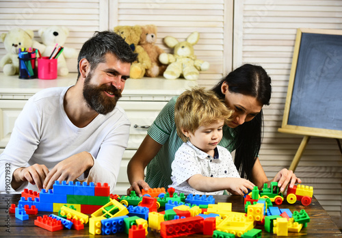 Love and family game. Mom, dad and boy with toys