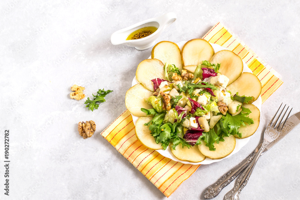 Salad with pears, feta cheese, salad mix and walnuts Salad with pears, feta cheese, salad mix and walnuts