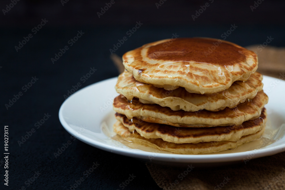appetizing pancakes with honey on a dark table. Menu , restaurant recipe concept. Served in. appetizing pancakes with honey on a dark table. Menu , restaurant recipe concept. Served in.
