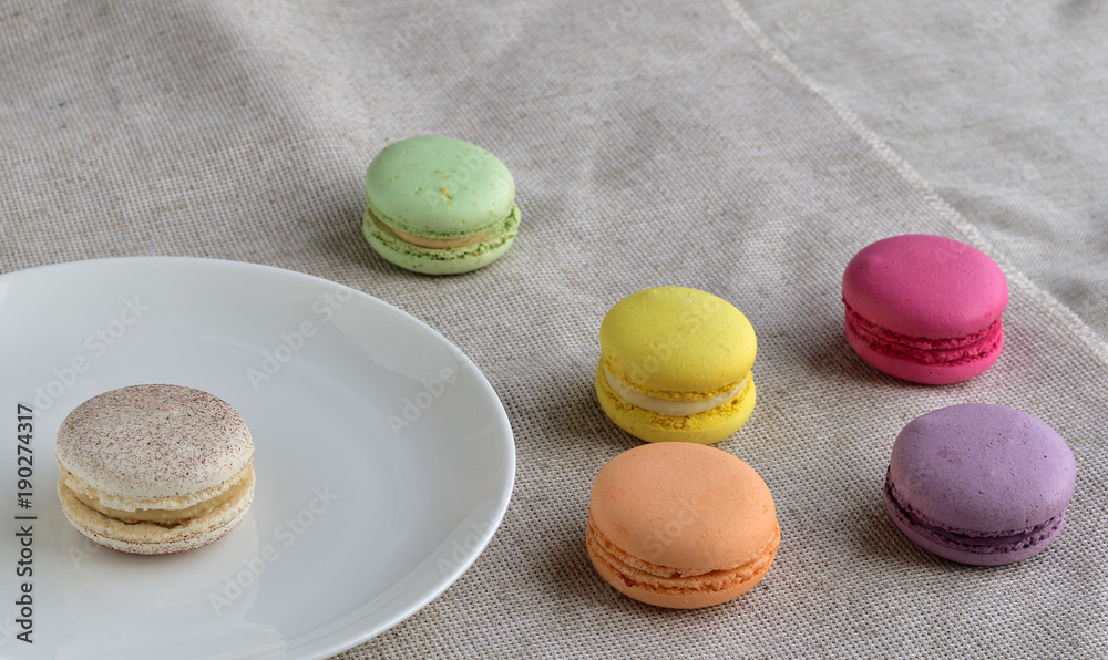 Tasty french assortment of macaroons on cloth with vintage color tone, a French sweet meringue-based cookies Tasty french assortment of macaroons on cloth with vintage color tone, a French sweet meringue-based cookies