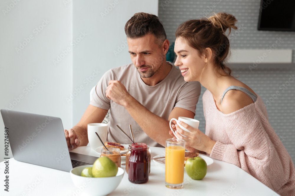Portrait of a cheerful loving couple having breakfast Portrait of a cheerful loving couple having breakfast