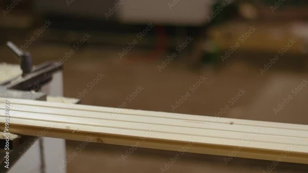 Wood board sliding out carpenter refiner machine at sawmill factory, lots of sawdust