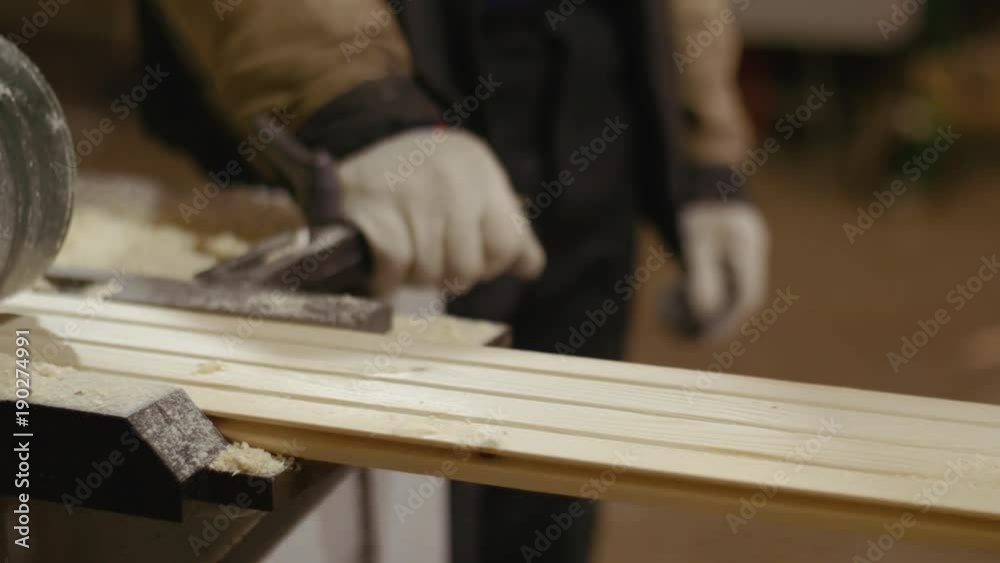 Wood board sliding out carpenter processor machine at sawmill factory, lots of sawdust Wood board sliding out carpenter processor machine at sawmill factory, lots of sawdust