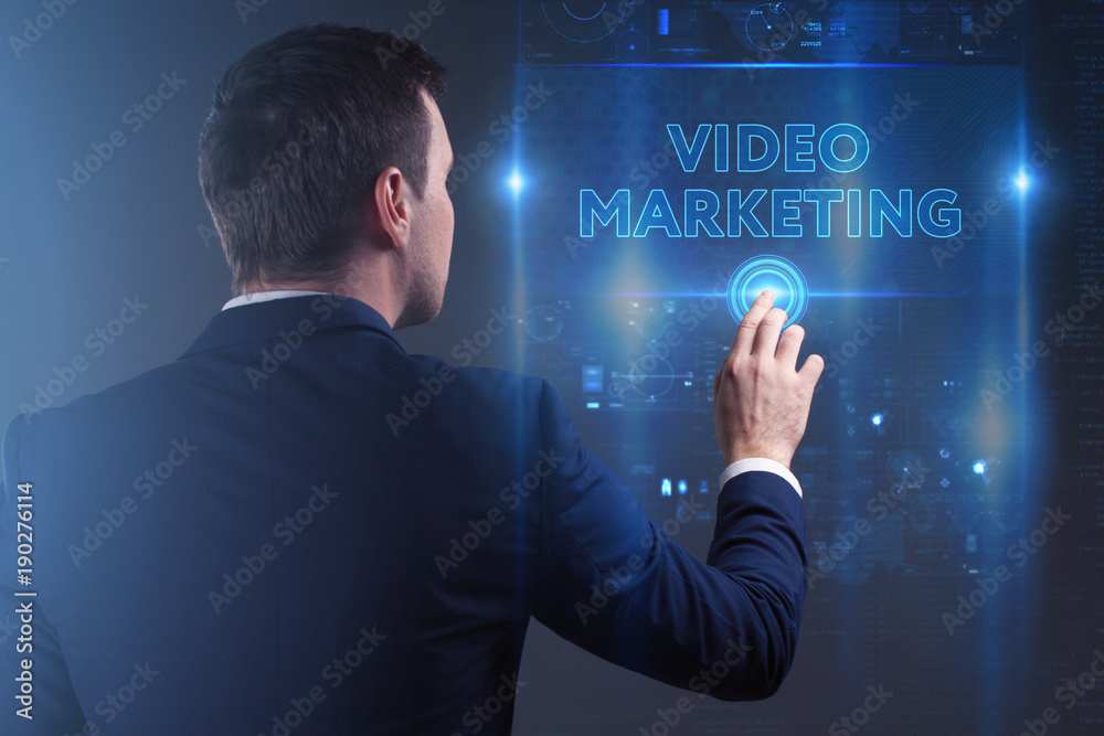 Business, Technology, Internet and network concept. Young businessman working on a virtual screen of the future and sees the inscription: Video marketing Business, Technology, Internet and network concept. Young businessman working on a virtual screen of the future and sees the inscription: Video marketing