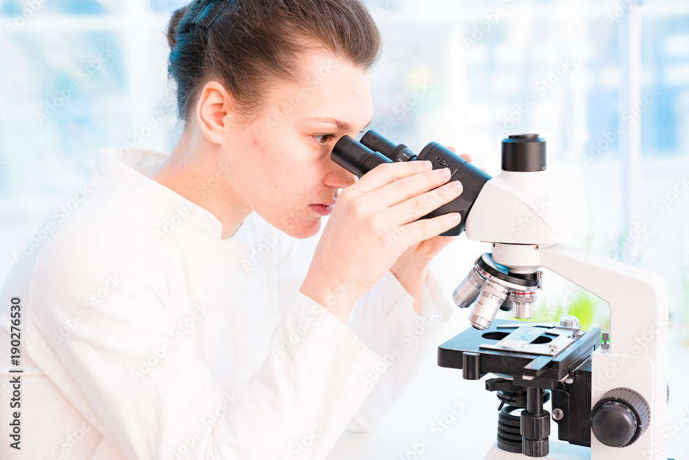 Young female technician in the laboratory of food quality control Young female technician in the laboratory of food quality control