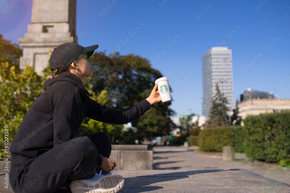  caucasian woman drinking hot beverage coffee outside