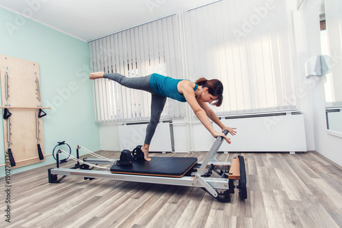 Woman exercising on pilates reformer