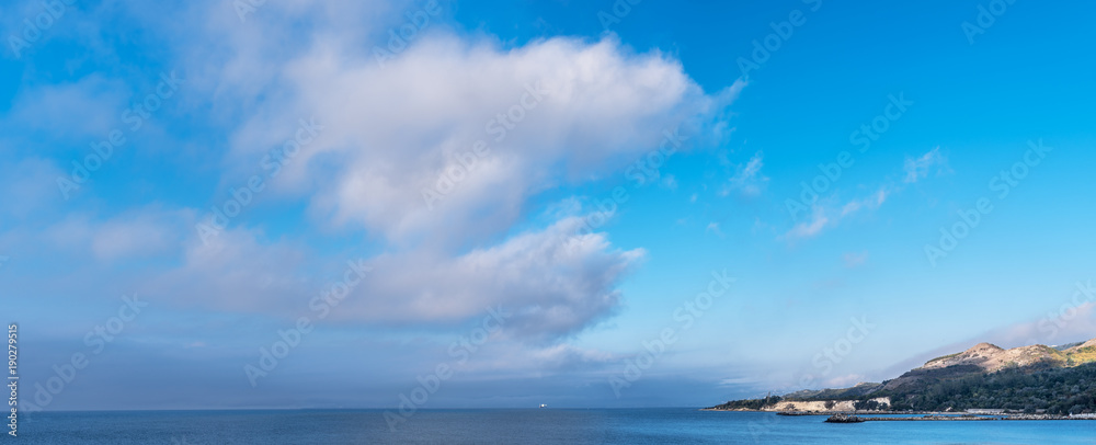 Calm sea and heavy clouds in the sky. Nature background.