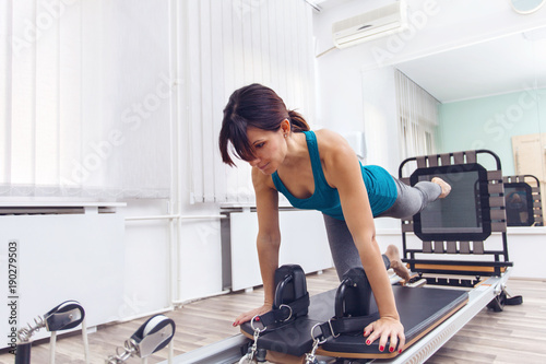 Woman exercising on pilates reformer © Svetlana
