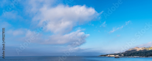 Calm sea and heavy clouds in the sky. Nature background.