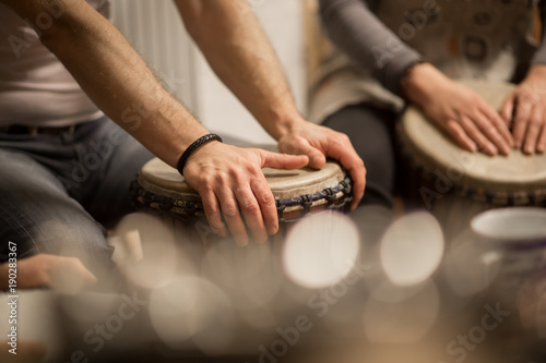 Close up of hands on african drums  drumming for a music therapy