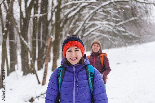 two girls go on a hike in winter