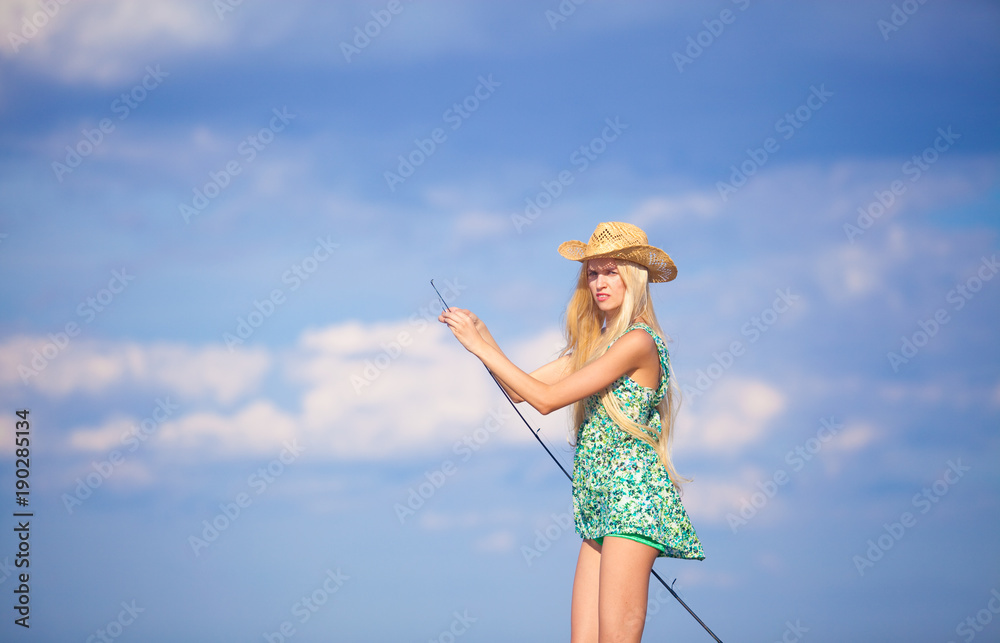 slender young blonde girl fishing on boat