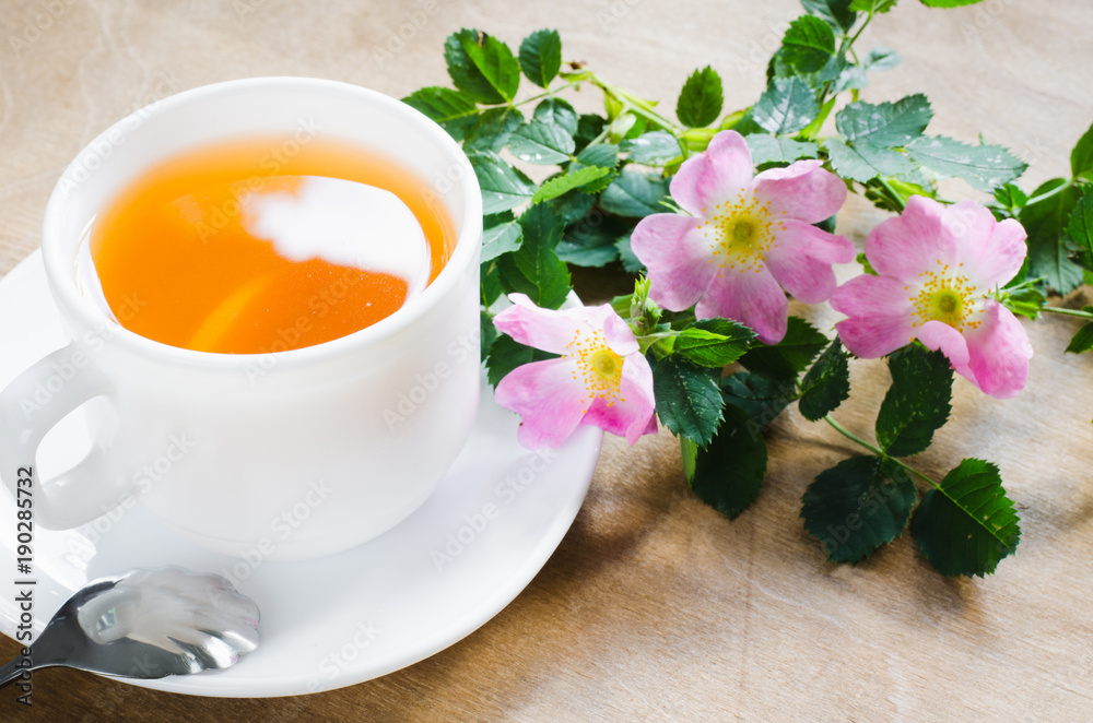 Cup of morning tea with lemon and delicate flowers Cup of morning tea with lemon and delicate flowers
