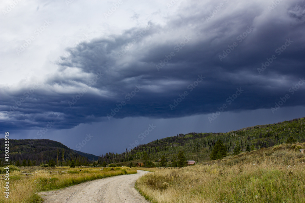 Thunderstorm Blowing in over a Dirt Road through the Colorado Rockies